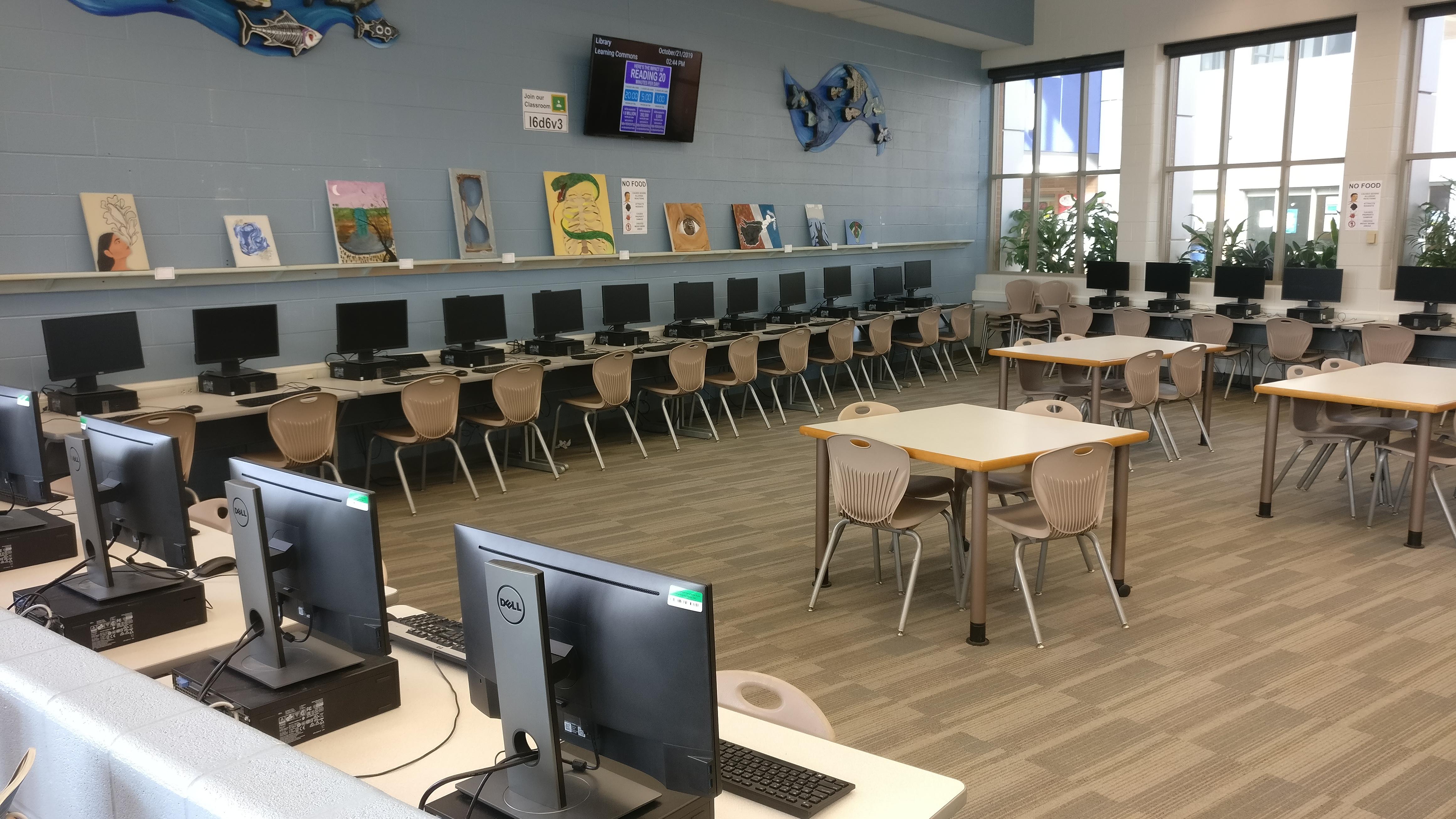 Desktop computers aligned along the wall.